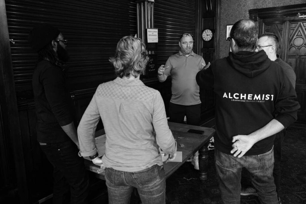 Grayscale image of a learning and development briefing with attentive participants.