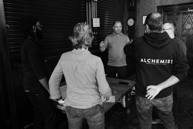 Grayscale image of a learning and development briefing with attentive participants.