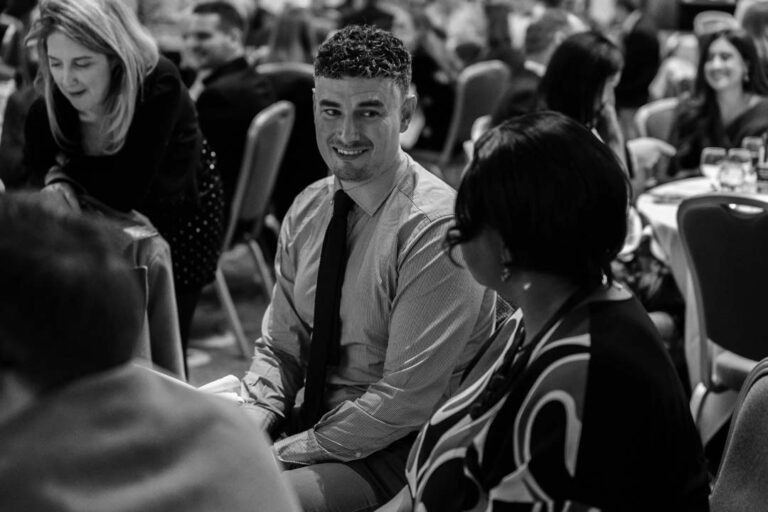 A confident speaker addresses an attentive audience during a workshop.