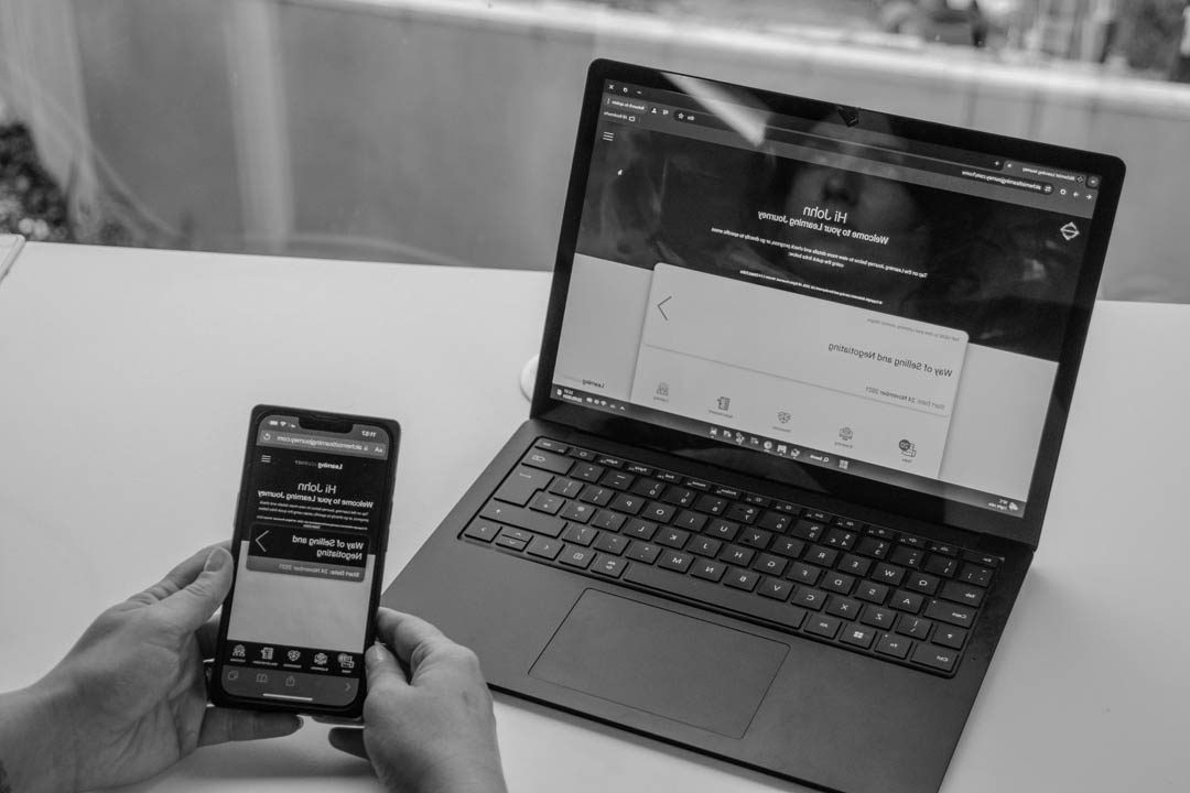 A photograph showing a mobile phone and laptop, both using the Alchemist Learning Journey.