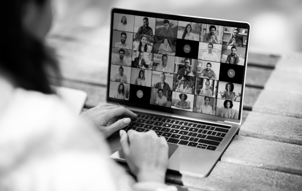 A person participates in online learning via a laptop.