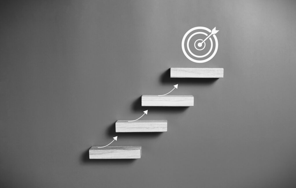 A set of steps leads upwards towards a target.