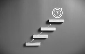 A set of steps leads upwards towards a target.