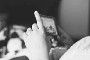 A person streams content through their phone while sat down.